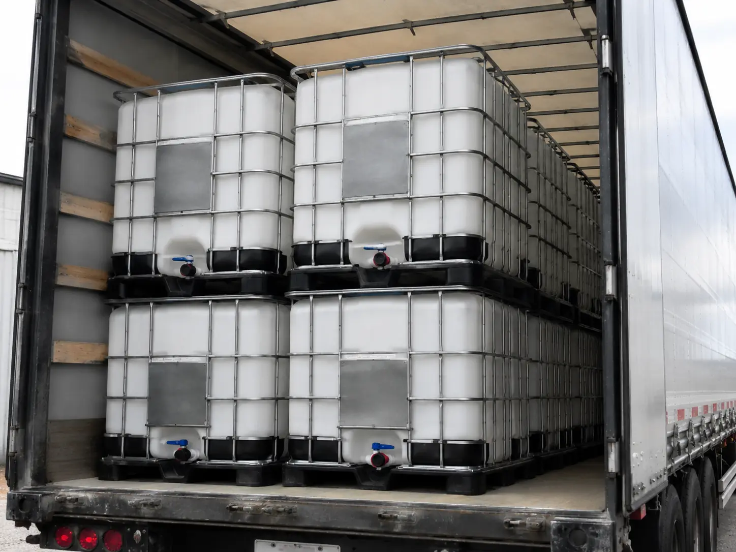 Curtainside trailer loaded two high with clean reconditioned IBC totes